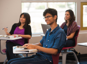 Smiling male student in class