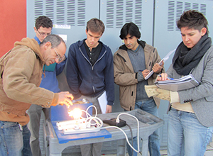 students and professor designing lighting testing apparatus