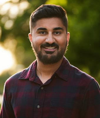 Portrait of Qamar Muhammad Ali in natural outdoor setting.
