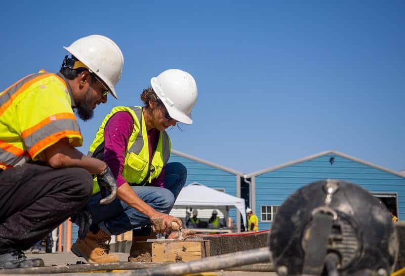 Lab2Slab researchers lay pavement at a recent event